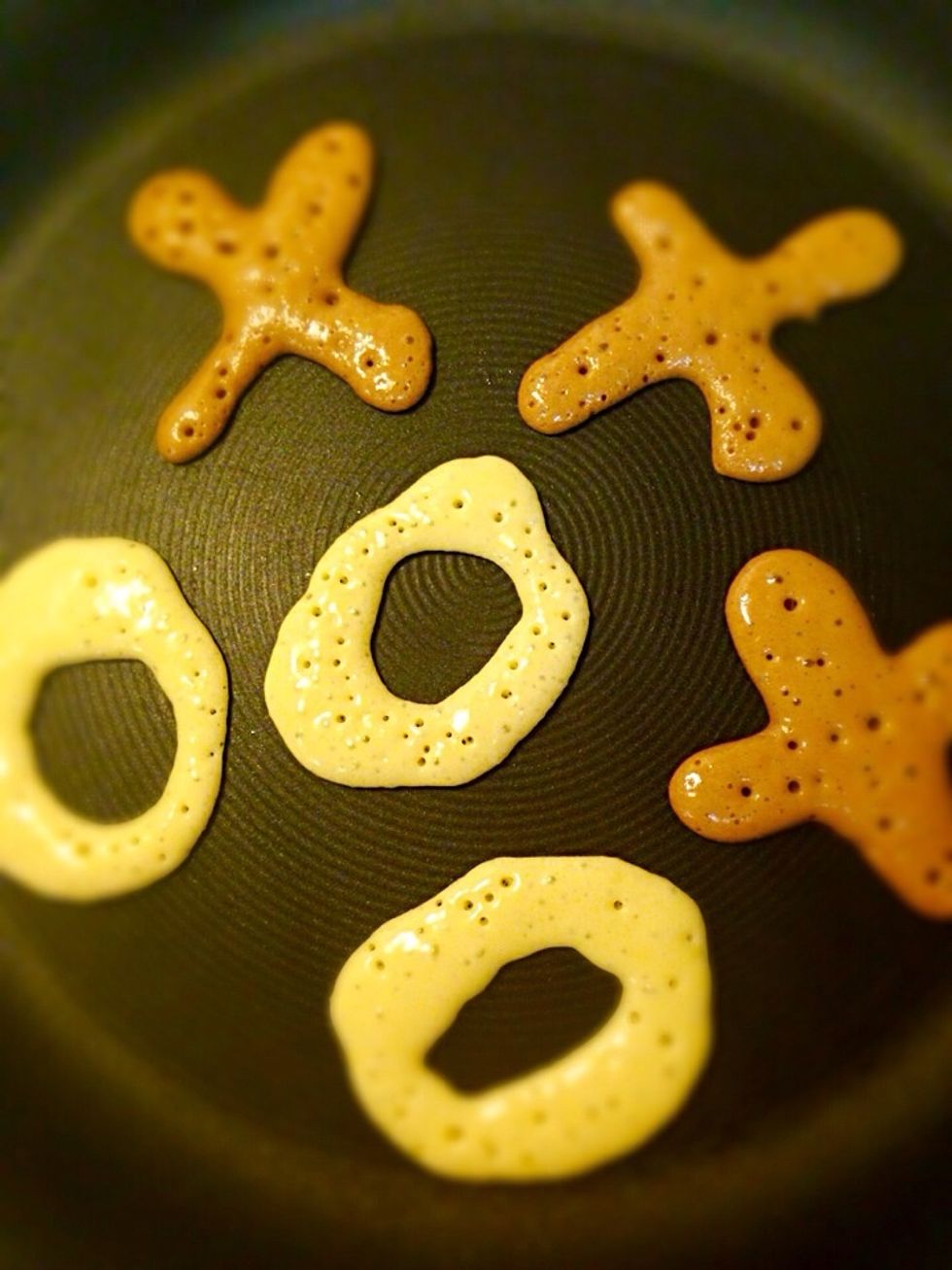 It's time for frying :-) Heat large nonstick pan on low medium heat. Pour white pancake batter in O shape and chocolate batter in X shape. Fry on both sides