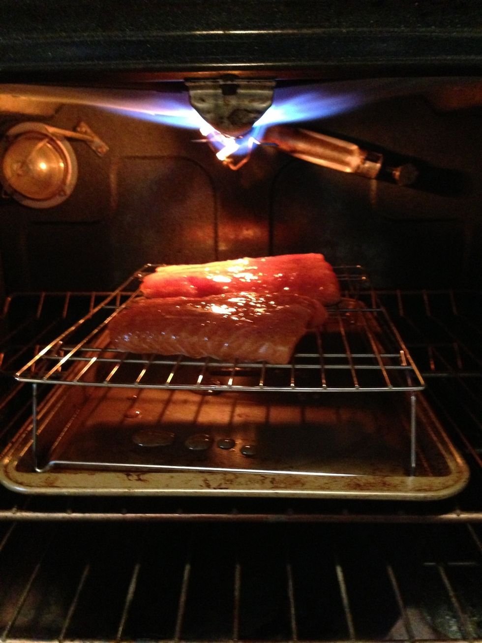 It's time to broil. Give your fish 6-8" of headroom. Cook 5-7 minutes and then rotate your pan 180 degrees, then cook another 5-7 min. You're too close to the fire if the top starts to char too fast.