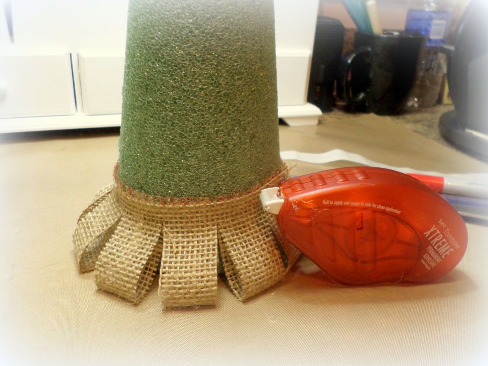 It's time to make a tree! Use your largest strip with the adhesive on it and wrap it around the bottom of the tree. See how the cut areas open up??