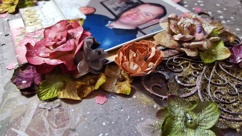 It's time to start adding the flowers. Add some under the journal/photo layers and some on top of them to add depth  to the layout. And remember to overlap some to make it look a more natural cluster.