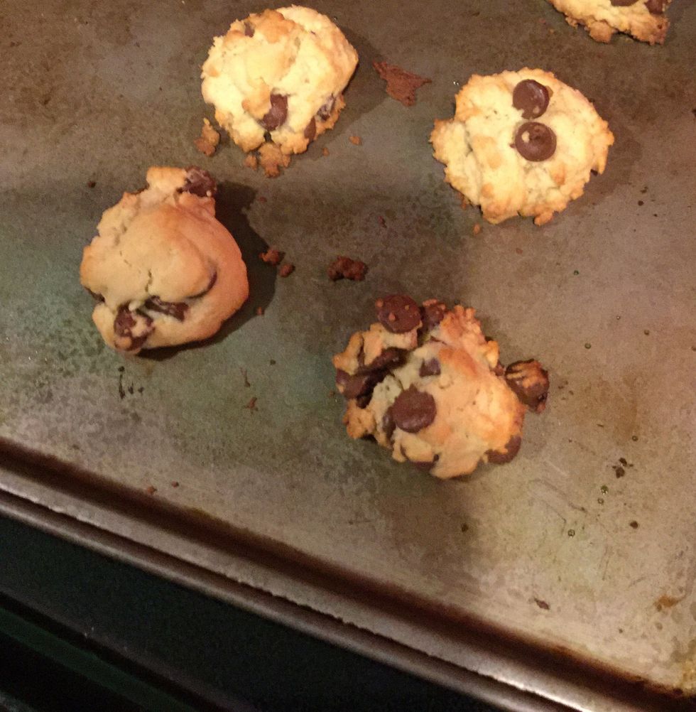 It's time to take the cookies out of the oven! Take a hot pad and set it on the counter, using oven mitts take your cookies out of the oven. Set the cookie pan on the hot pad.