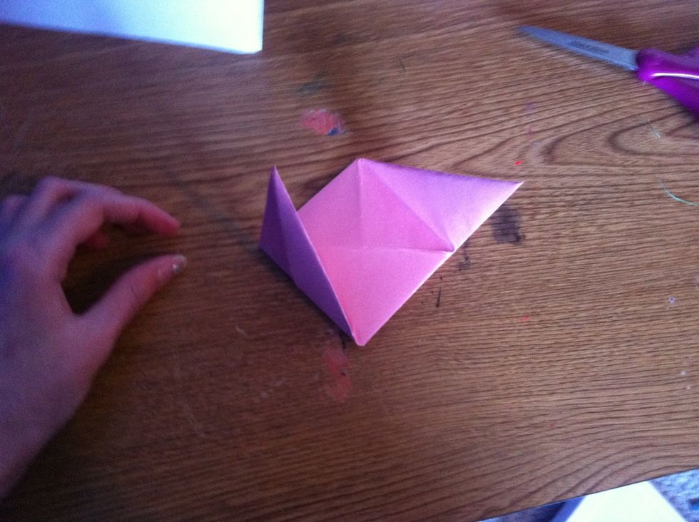 It should look like a square with flaps on the sides.