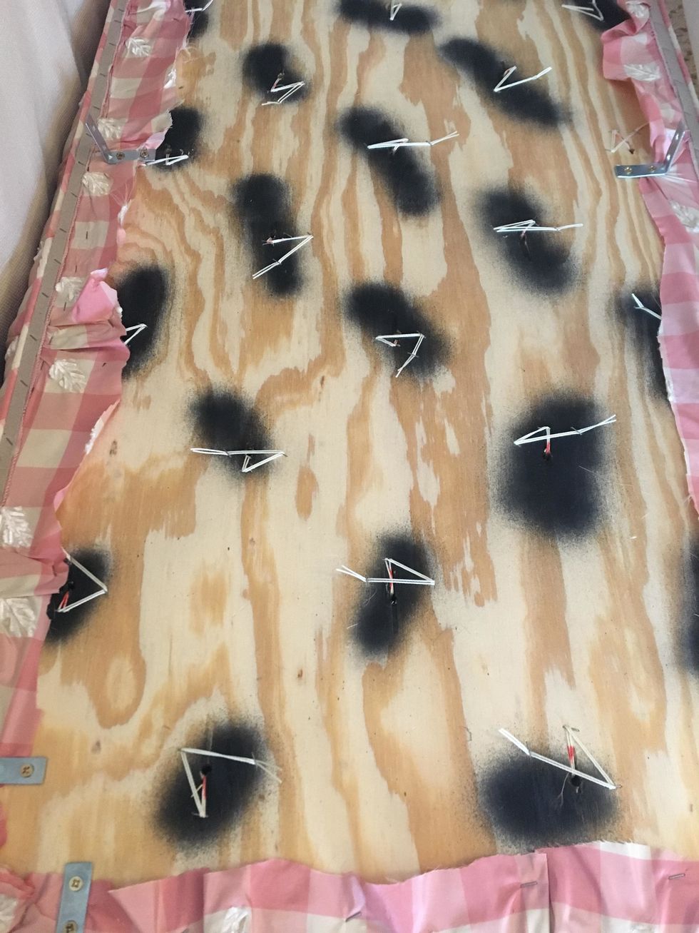 It should look like this when you have all the buttons pulled and the piping/cardboard strip is stapled onto the back. Note the zigzag stapling of the cord. This keeps the buttons nice and tight