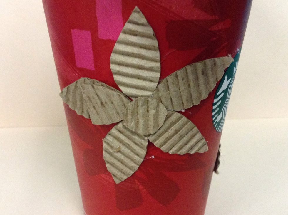 It should look something like this. Add another flower on the other side of your cup.