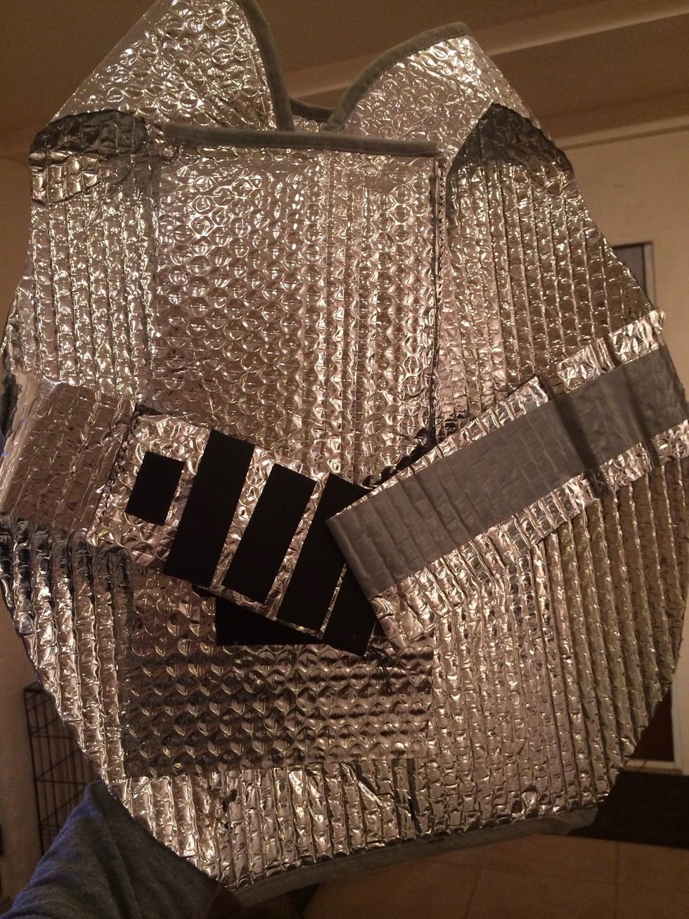 It should look something like this. One strap should Velcro to chest plate and then the other strip should Velcro overlapping the first strip