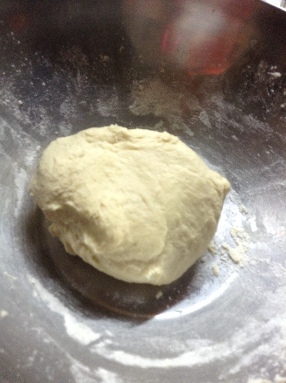 It will be ready when the whole dough stops falling apart to pieces  and is not sticky anymore