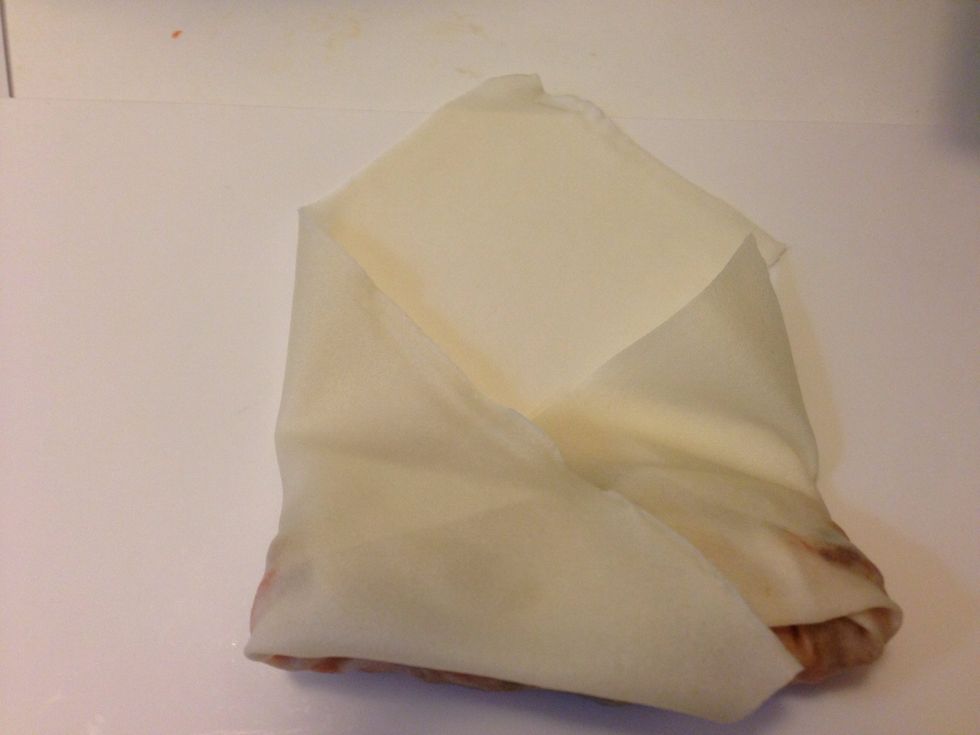 It will look like this. Continue to roll it all the way and at the end, place some of egg whites so the paper will stick together.