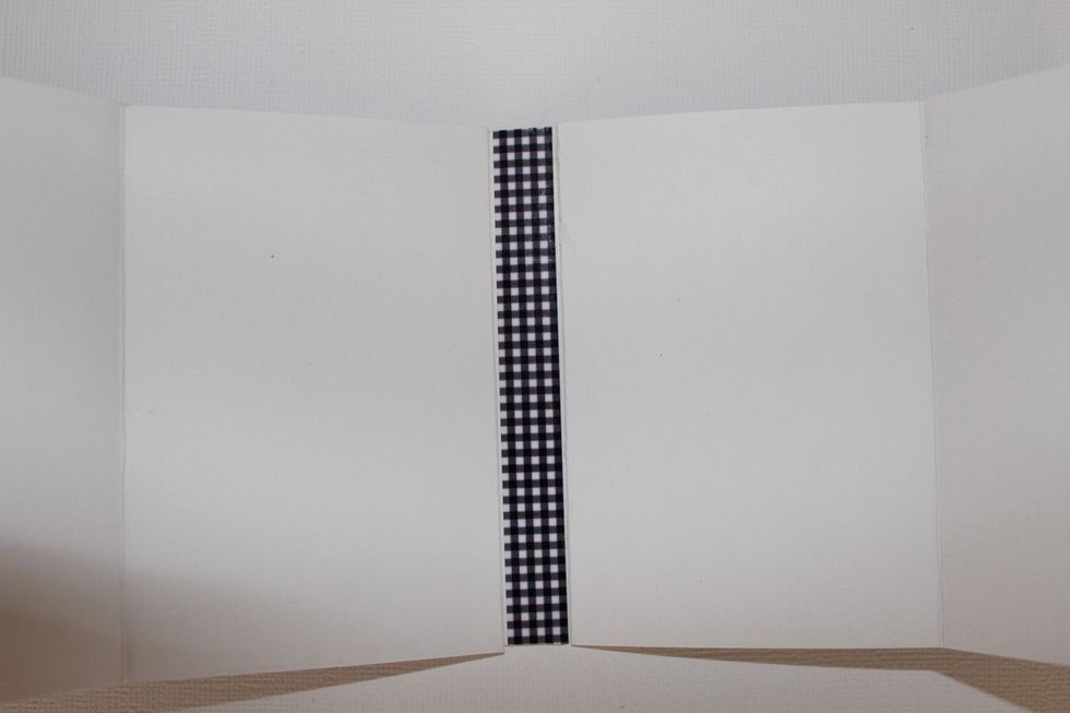 Join the three pieces. The 1" border punched upside down, one to the left, stick at the 1 1/2" piece in the left 1/2" flap. The same with other accordion, sticking the 1" border with the right flap.