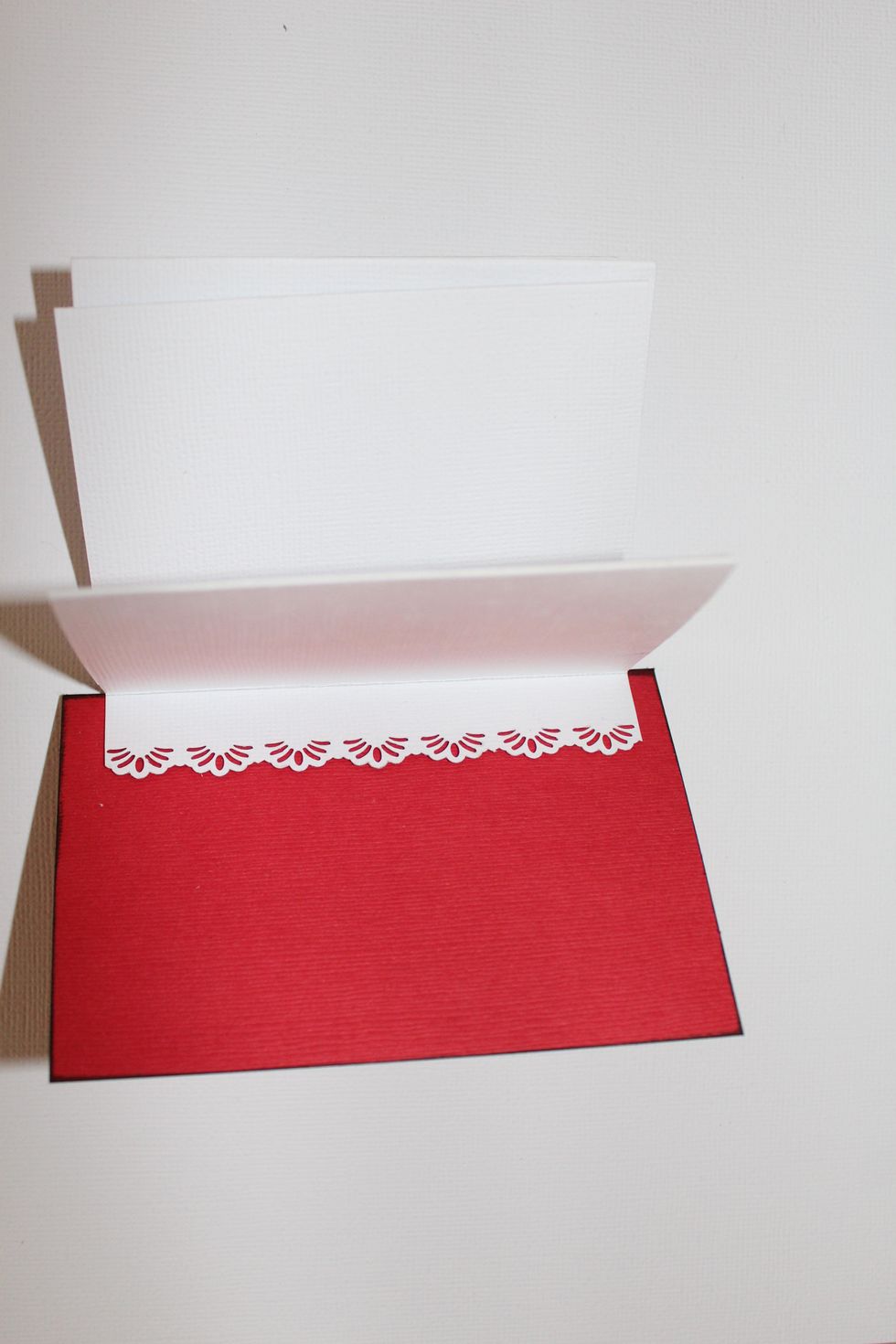 Join up the right flap with one red cardstock piece on the left side, allowing 1/4" at top and 1/4" at the bottom. Same process with the left flap on the right side of the other red cardstock