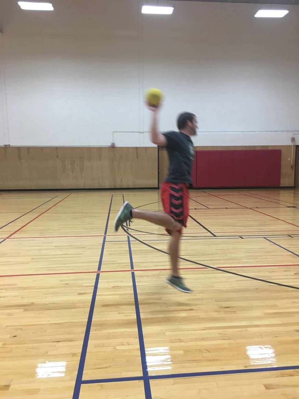 Jump in the air while raising shooting arm up and back to make an L, or a 90 degree angle. Rotate shoulders square to the goal whipping throwing arm forward.