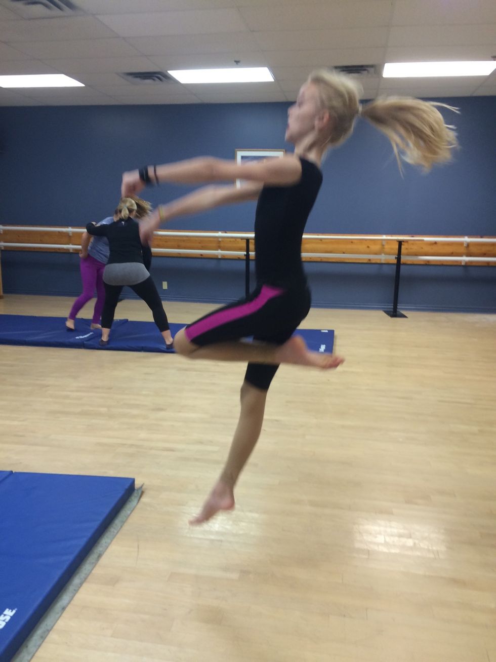 Jump up and put your arms to the sky also raise your foot to your knee