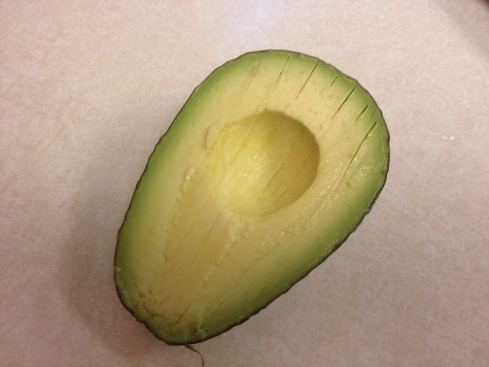Just before serving add one diced avocado. Make a cut length wise around, but not through the seed. Twist each side and it will split apart. Cut lines down the length without piercing the skin.