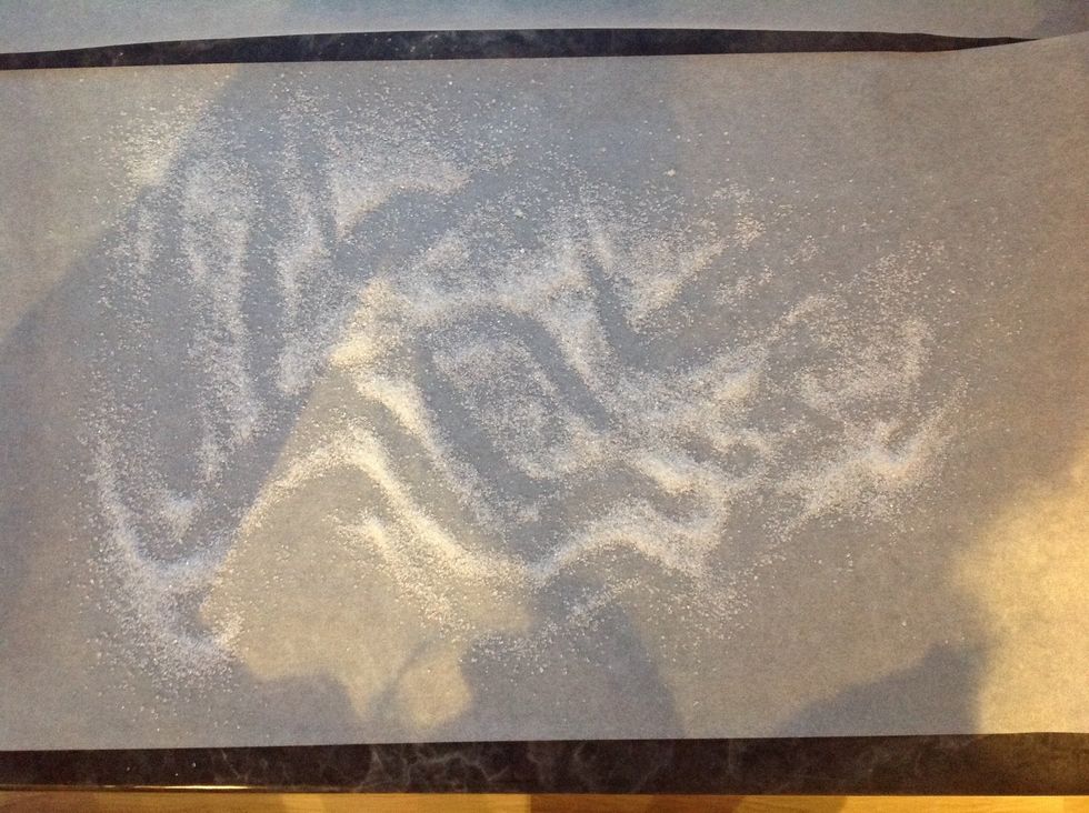 Just before the 20 minutes are up get another sheet of baking paper, placed on your counter and sprinkle it with a spoon of sugar.