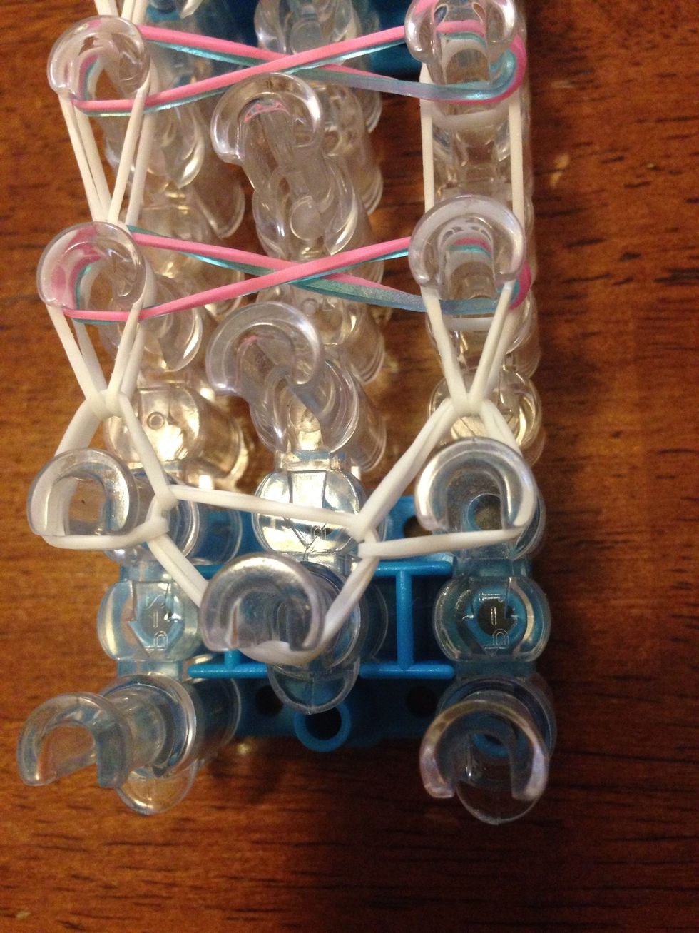 Just like the other side, grab the band that is loose and put it on the next one.