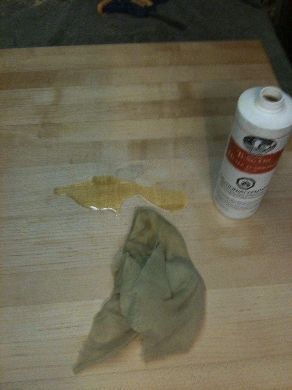 Just pour a little in the center and start spreading it all over. I used a lint free rag to spread oil. Dispose the rags in a safe manner, it could start a fire if disposed incorrectly.