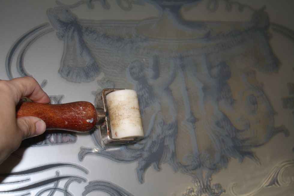 Just to be sure all of my image was being transferred, I used a brayer to go across the surface. Since I wouldn't be distressing the mirror, I wanted this to transfer perfectly.