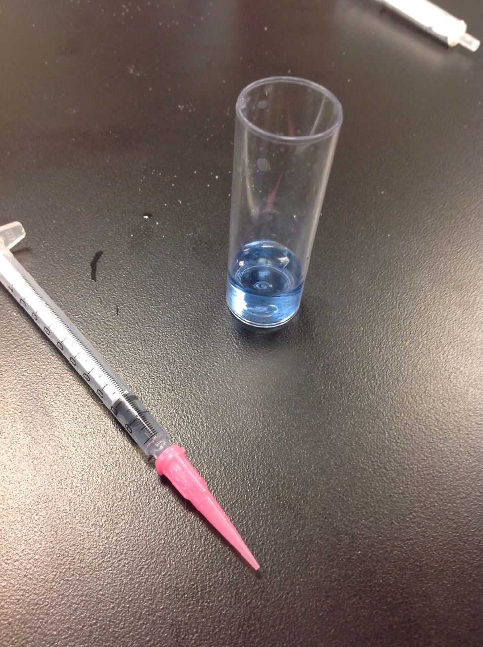 Keep adding drops and swirling until the liquid in the vile turns blue like this. Look at where the end of the plunger is and make a note of that number.