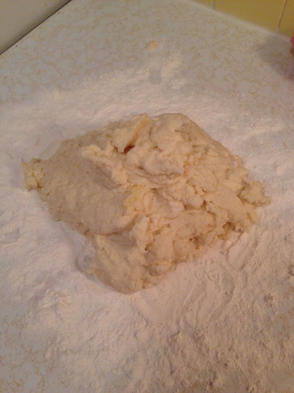 Keep adding more flour. As soon as it turns to sort-of-dough consistency, dump it on your counter and work it with your hands. (Don't forget to keep adding flour.)