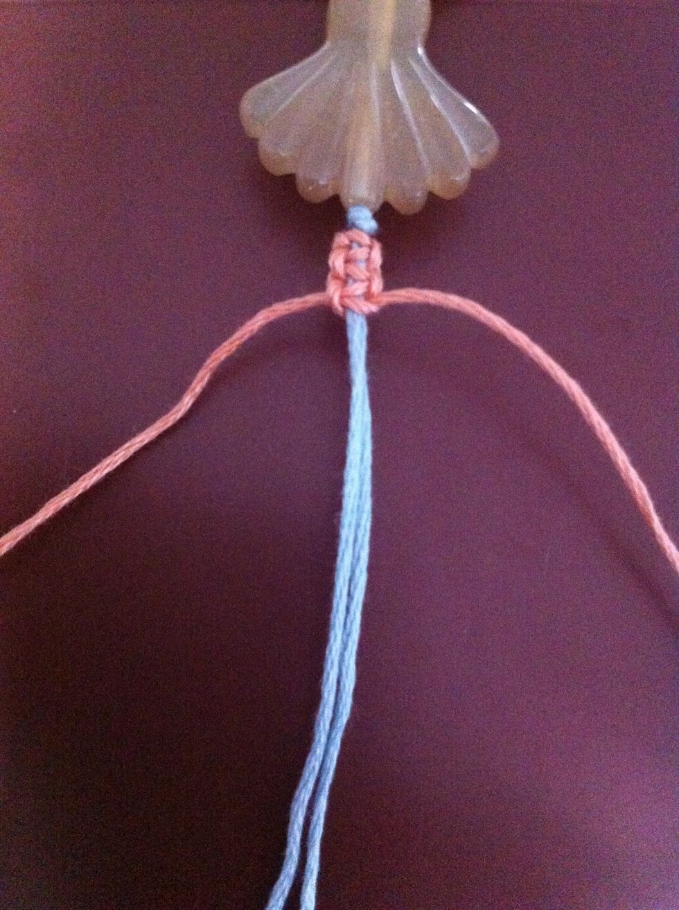 Keep alternating knotting sides. This is what it should be looking like. Once finished knotting down this side of the charm, take the second 60cm pink cord and do the other...