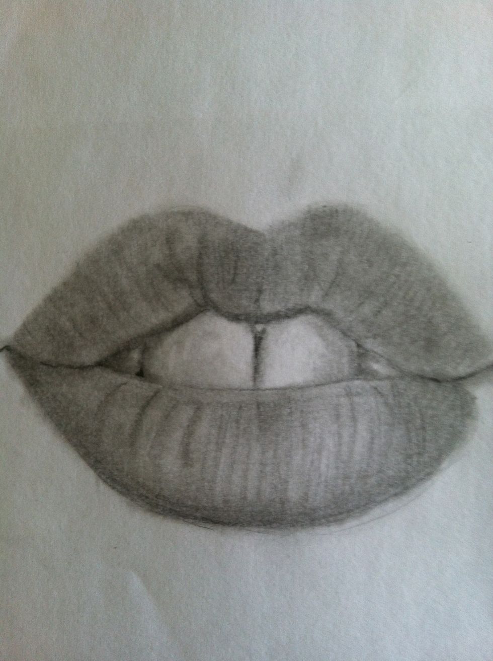Keep blending everything, start shading more of the teeth. Figure out were the light is hitting the lips and take your eraser to make that area lighter