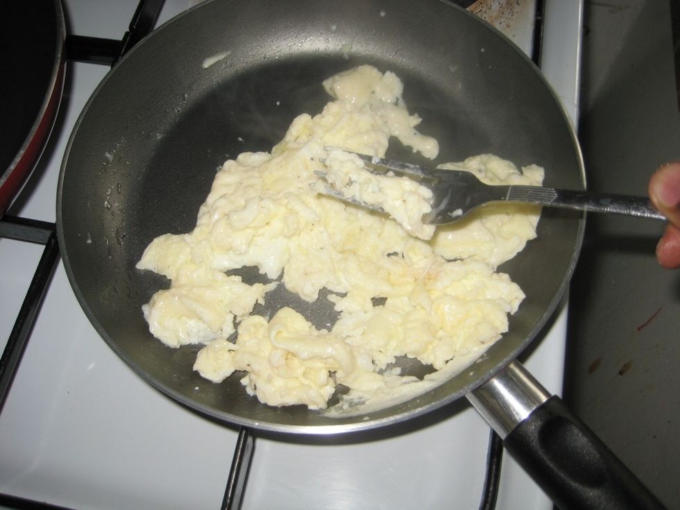 Keep breaking the lumps, careful the egg doesn't brown. If the pan is too hot, move it away from the fire and keep stirring.
