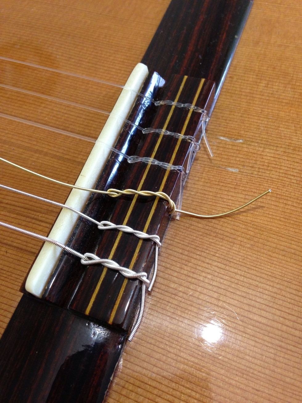 Keep crossing the string over itself. Two more 'crossings' will be enough.