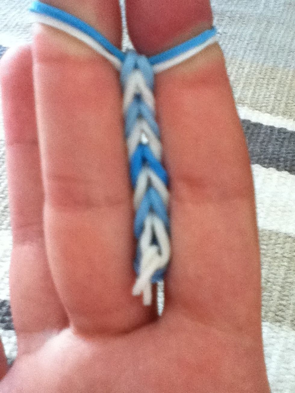 Keep doing that until it looks something like this. Don't stop yet. Keep doing it until its big enough for your wrist. But remember it stretches