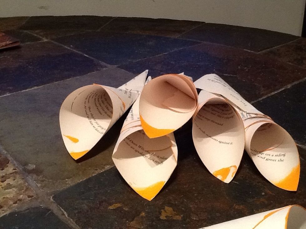 Keep doing this until you have a healthy stack of petals to make your flower. Also want to add here that I finger-painted the corner of each page as well, but this step is all up to artistic taste :)