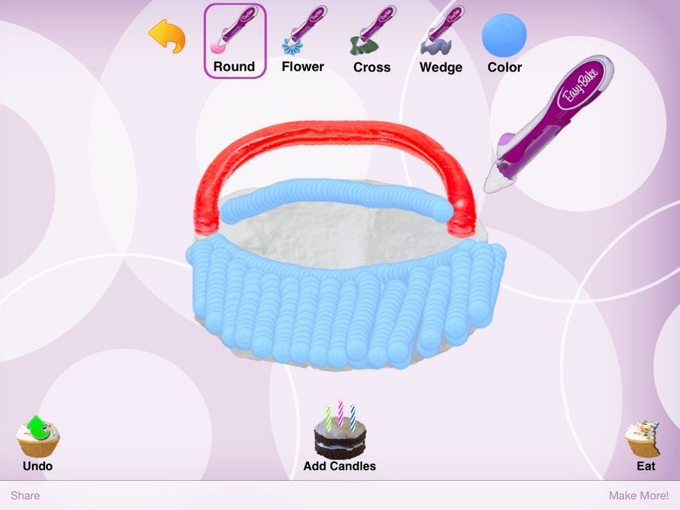 Keep drawing lines next to it to cover the whole bottom in blue. Try and not let it go off the bottom of the cake. It's better to have it not go all the way than have it go over. Go over any mistakes.