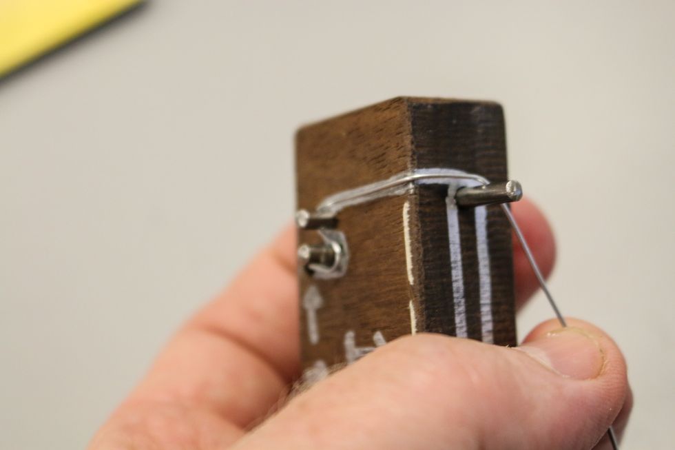 Keep following the line. Across each angle, try to bend the wire in sharp bends following the corners of the jig.