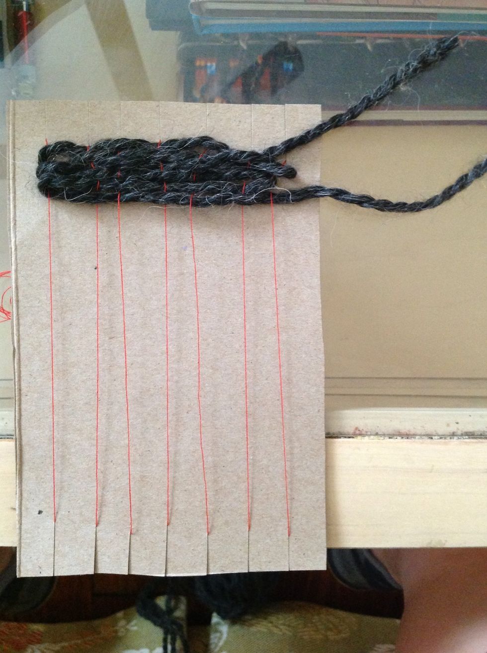 Keep going! And push the strings as far up toward the top of your loom with each row you weave.