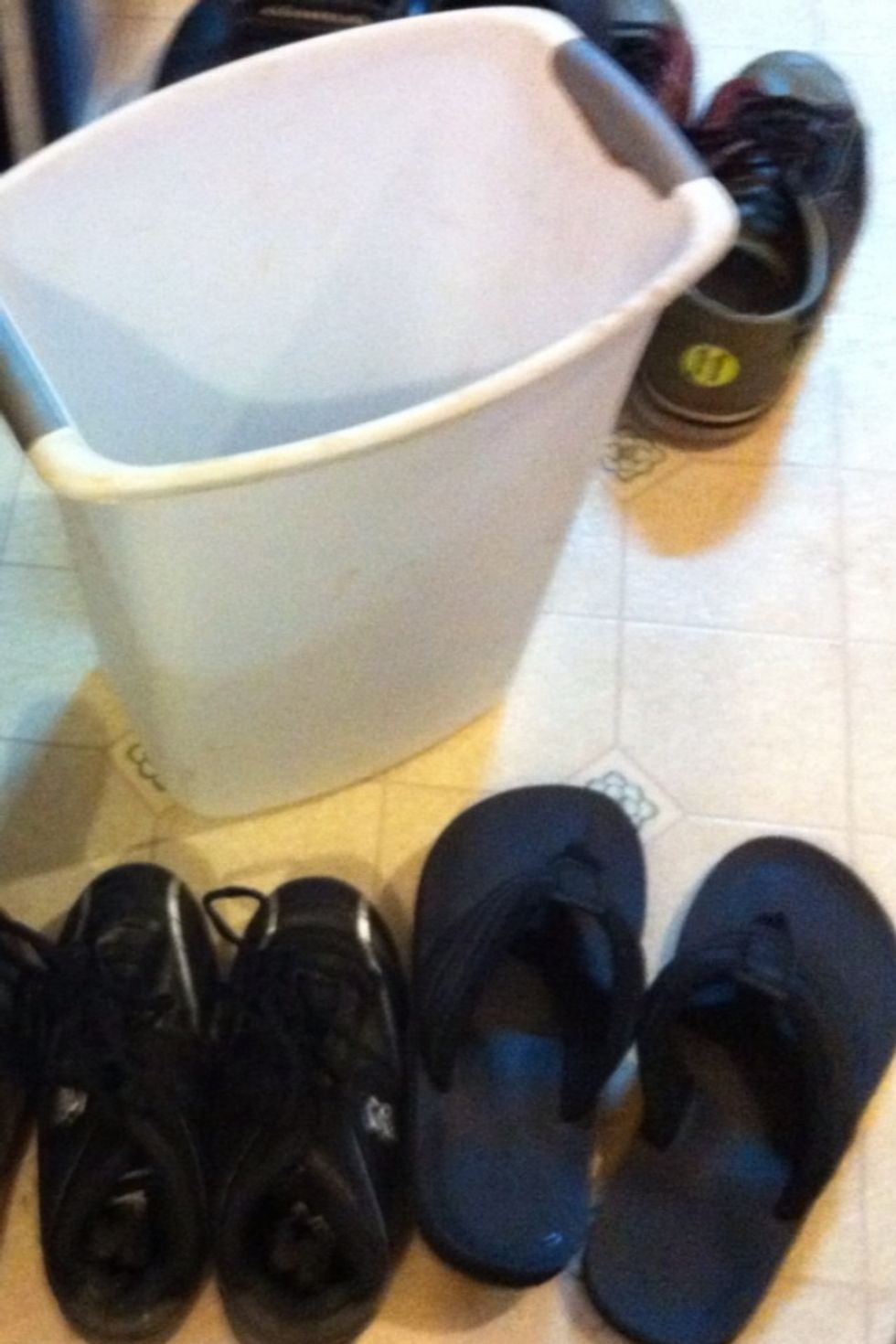 Keep going through pile until have what will fit in designated space. These shoes, plus the shoes he has on will nicely fit into this designated container and be easily kept clean. Sort other piles.