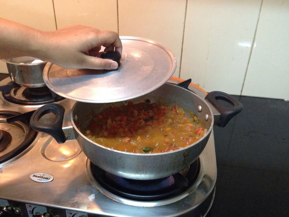 Keep it closed for a while but not for too long. This is to ensure that the tomatoes are mashed up along with the heat.