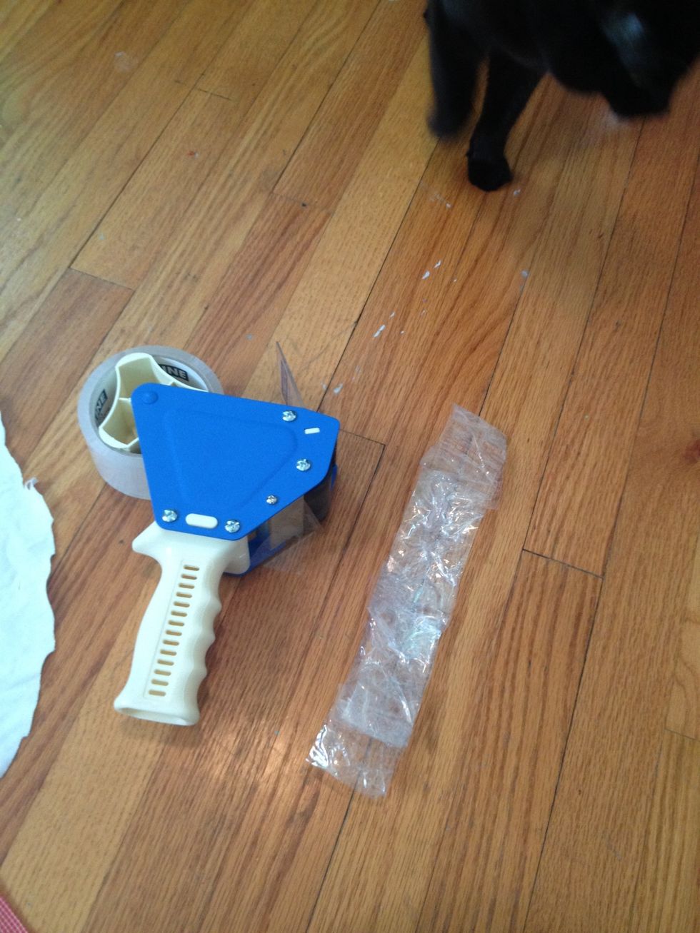 Keep layering tape, increasing the strap's length, until you think it would fit comfortably and loosely around your feline's neck.