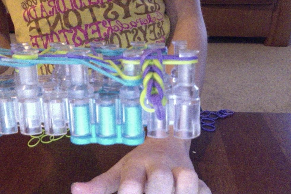 keep on doing that in till the rubber band bracket can fit around you're wrist