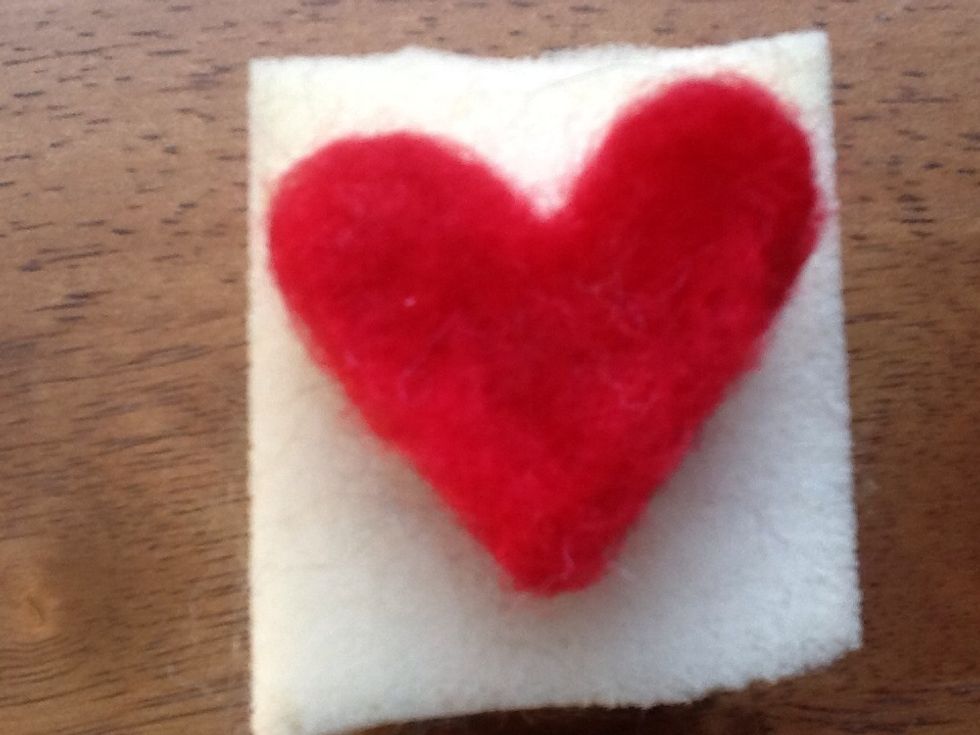 Keep poking the wool and it will start to look solid....occasionally turn it over and do the other side. next is a slide demo-ing the method