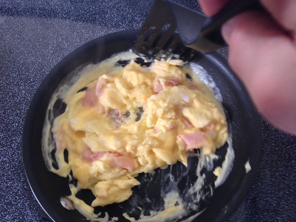 Keep pulling and pushing. You can even start digging beneath the eggs and flip them over. Note: if your eggs still look wet keep cooking! It's possible the temp wasn't high enough (by tiny bit).