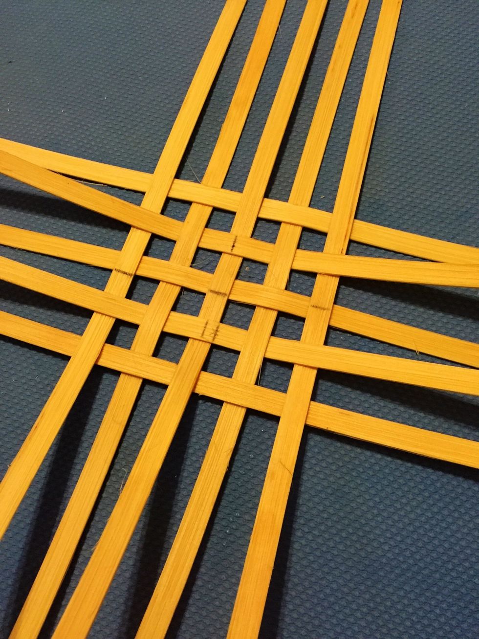 Keep repeating until all of your spokes are woven. The horizontal middles should align, and the vertical middles should align. Shift your spokes until the spaces between them are square.