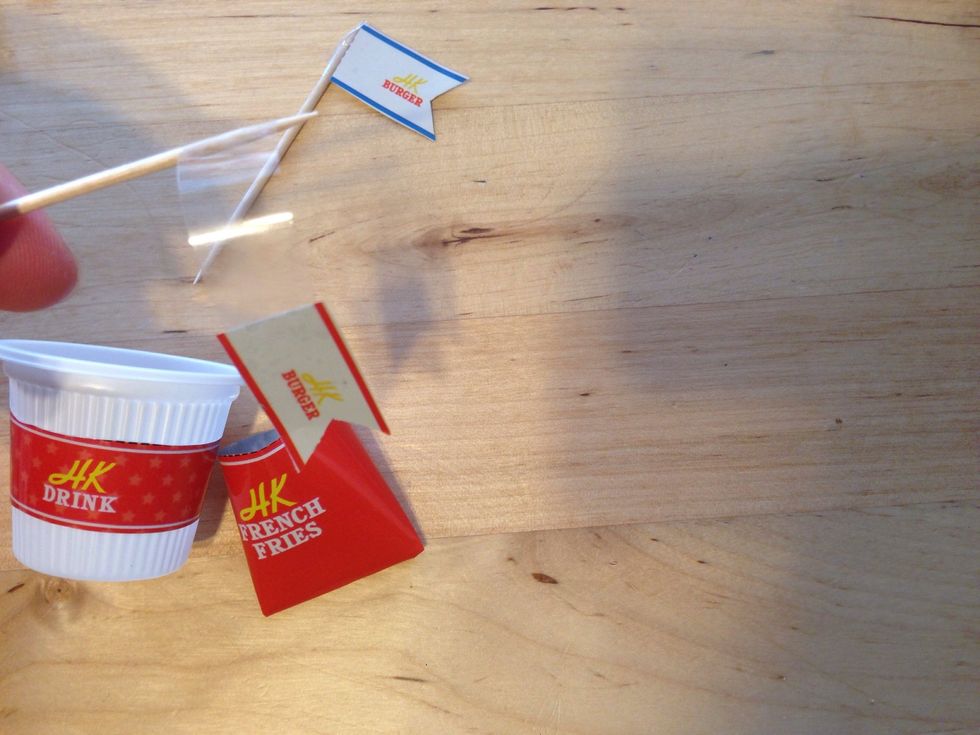 Keep rolling  tape until flag is flush with toothpick