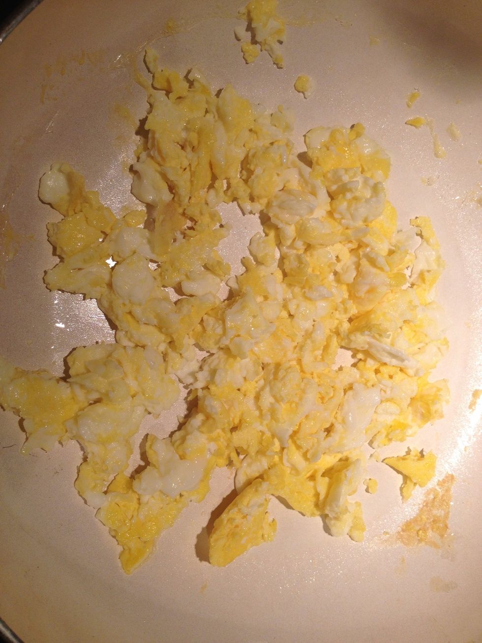 Keep scrambling until they are not runny and they are a yellowish white once they are you can turn off the stove