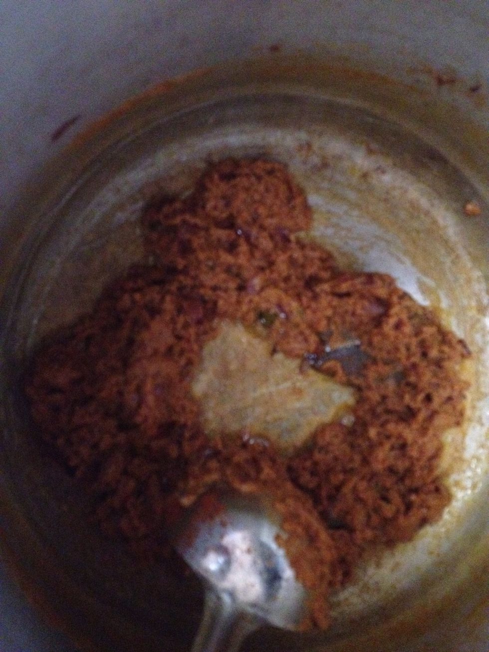 Keep stiring so that it doesn't stick to the bottom and keep the flame low once it looks like this add tamarind paste & water and get it to a boil