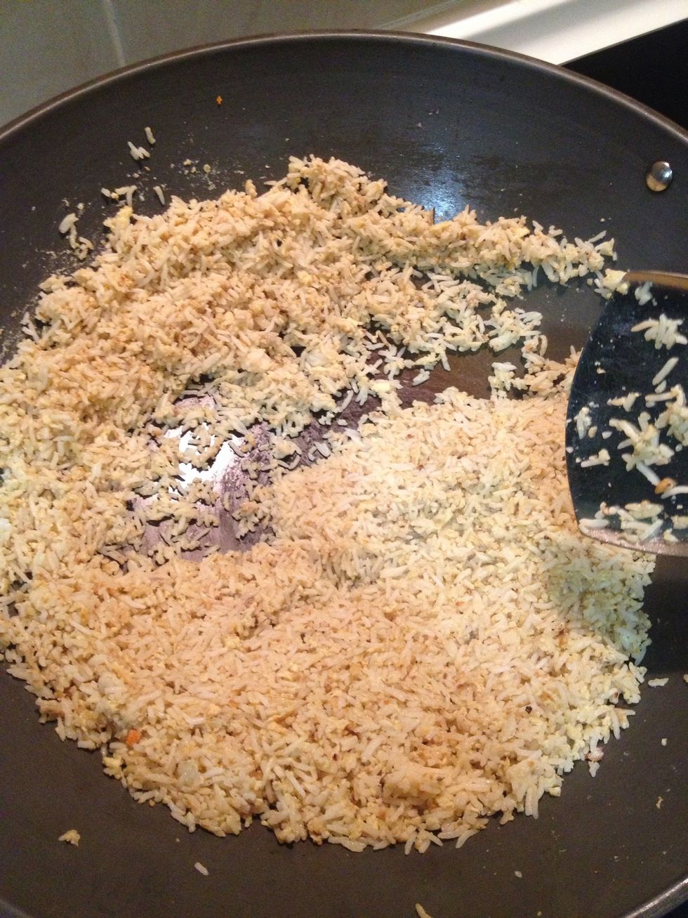 Keep stirring and try to spread the rice around the wok. Keep frying for about 5 minutes until golden brown in high heat.