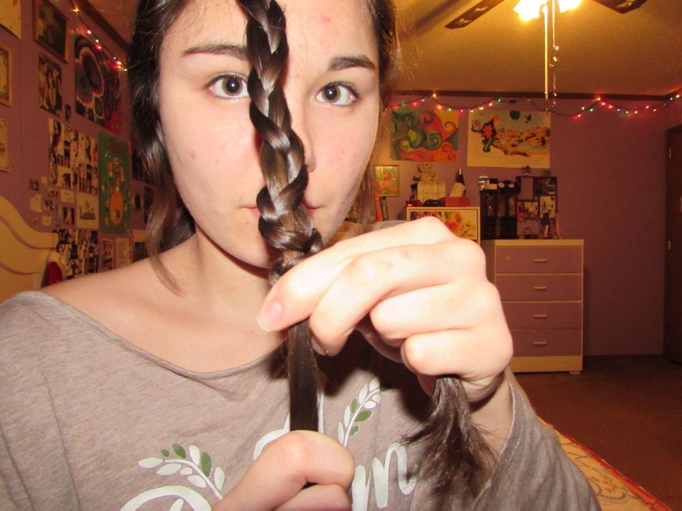 Keep that one strand VERY tight. Hold on tight to the other two strands as you push them up the solo strand of hair.