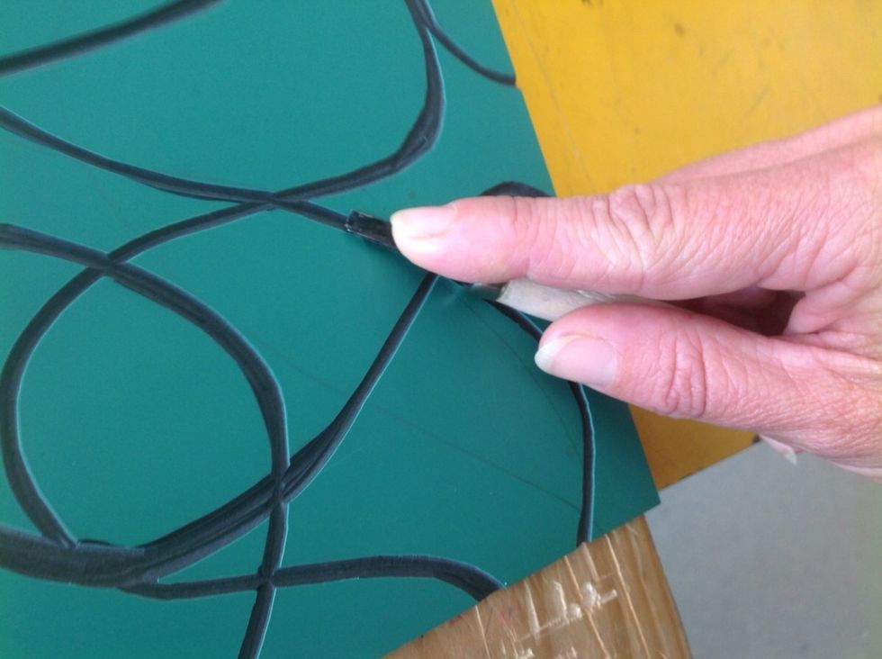 Keep the carving tool at an acute angle to the surface of the Lino so not to dig holes through the Lino.