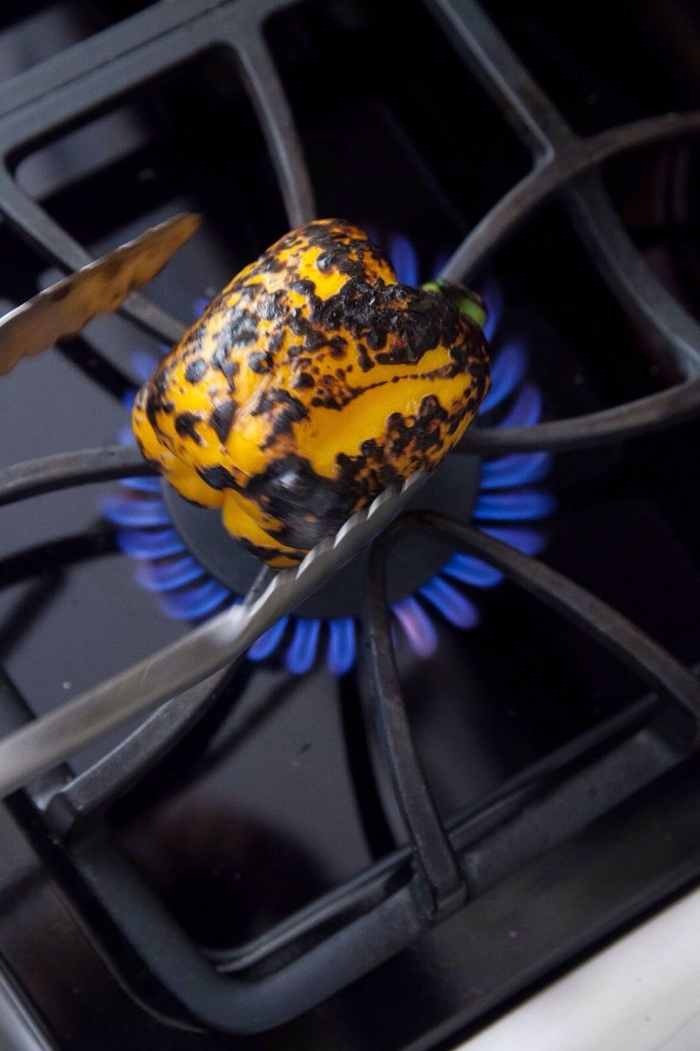 Keep the flame low, and keep turning the peppers till they start to char.