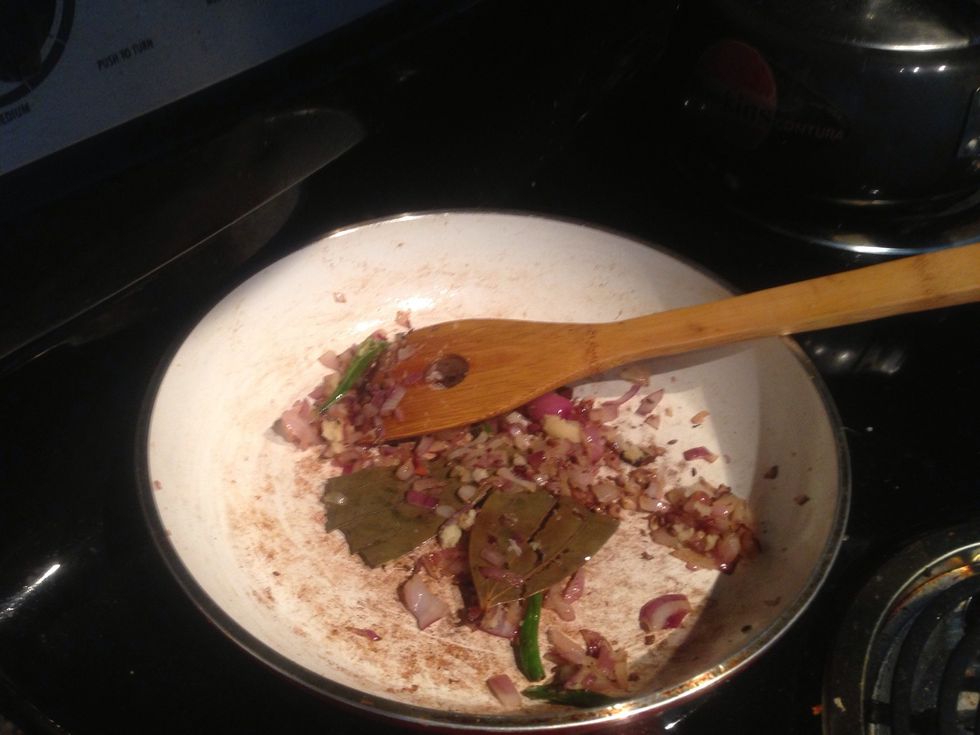 Keep the fried soya chunks aside. Heat the pan with some vegetable oil again. Put a bay leave, some cumin seeds and the sliced green chillies. Will put the lid on quickly as it will start to splutter.
