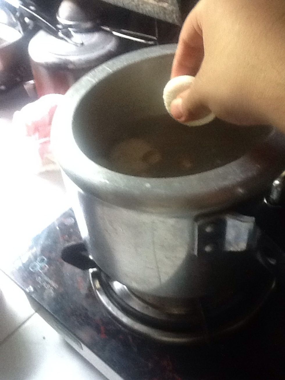 Keep the heat high. Then put the small balls you made earlier of chenna and close the cooker lid. Now keep the cooker on medium heat. After 5 minutes whistle will blow.