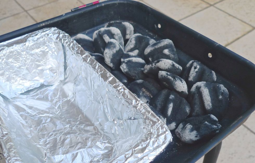Keep the hot coal on half the grill and cook on the cooler half. The idea is to keep the meat away from the direct heat. Next place a drip pan beneath the meat you are cooking on.