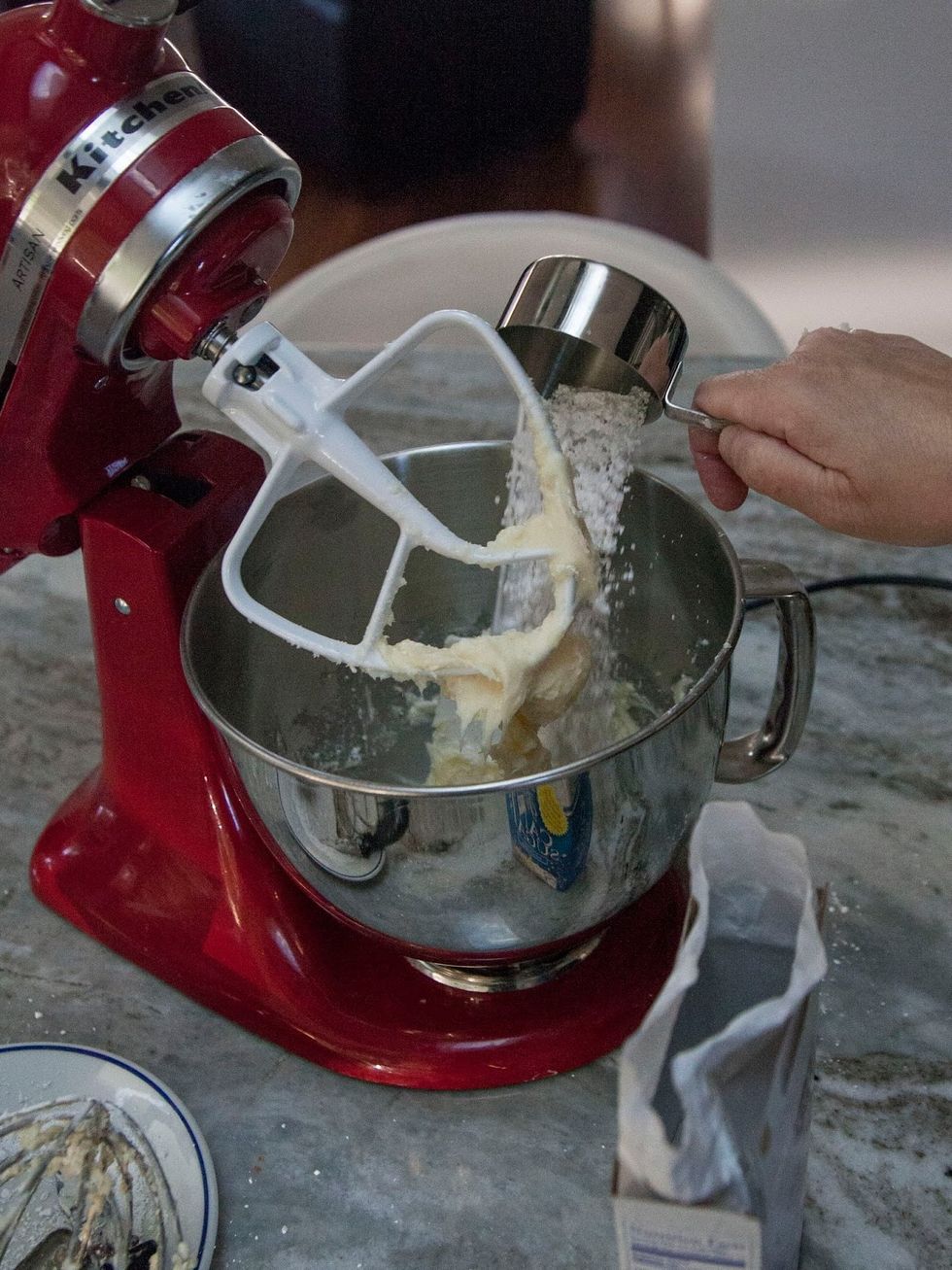 Keep the mixer on low speed and add in the powdered sugar one 1/2 cup at a time.