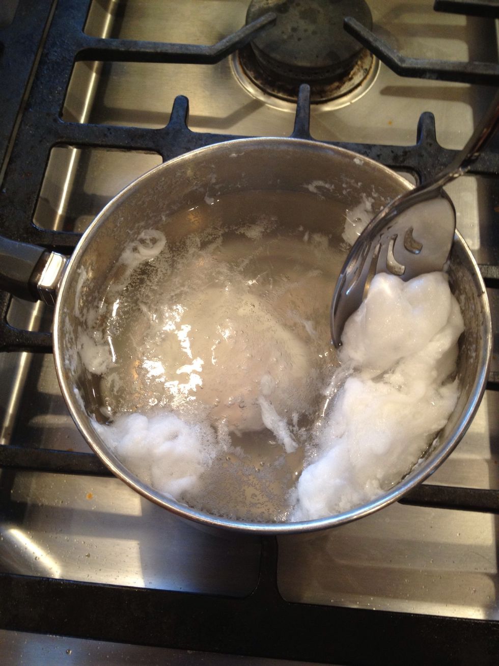 Keep the water just below a boil. If it boils and bubbles, skim the white foam off the top.